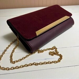Plum colored crossbody / clutch with gold details